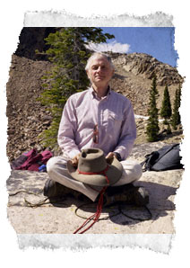 Erik Sorlie sits cross-legged on the mountain.